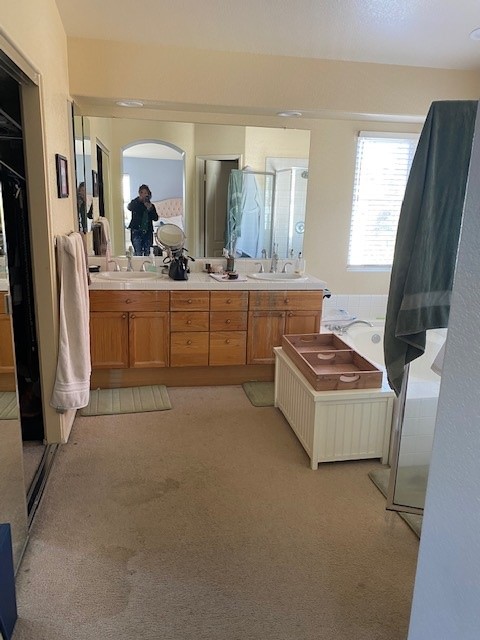 The bathroom before, with carpet and an older vanity